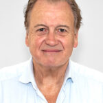 EIFA A person with short, light brown hair and a friendly expression is wearing a light blue collared shirt. With ties to London and an education from EIFA, their bilingual skills stand out against the plain white background.