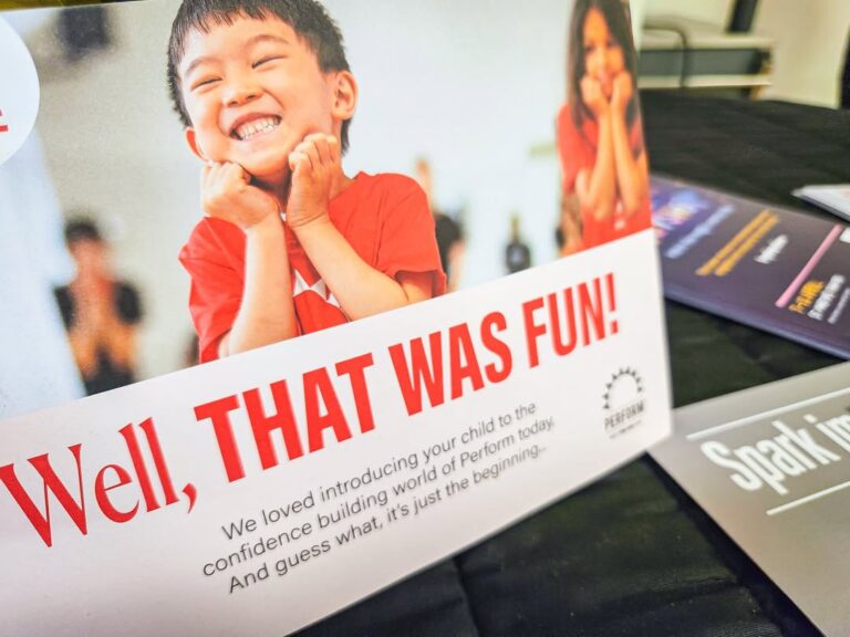 EIFA A postcard features a smiling child with hands on their cheeks and the bold text Well, THAT WAS FUN! Below, smaller text invites you to International Open Day and talks about introducing children to a confidence-building world of performance.