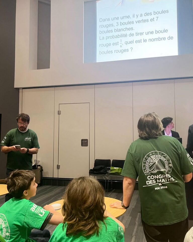 EIFA Four people in green Congrès des Maths shirts are in a classroom for International Open Day, studying a math probability problem about red, green, and white balls projected on a screen. Tables, chairs, and papers fill the room.