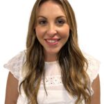 EIFA A woman with long brown hair wearing a white top smiling against a white background.