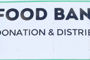 EIFA A large sign reads Food Bank Aid Donation & Distribution Hub with a green plate, fork, and spoon icon. Below, it says Supporting our local food banks—just as EIFA Pupils Explore the London Wetland Centre and support our community.