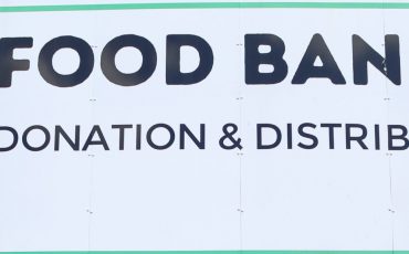 EIFA A large sign reads Food Bank Aid Donation & Distribution Hub with a green plate, fork, and spoon icon. Below, it says Supporting our local food banks—just as EIFA Pupils Explore the London Wetland Centre and support our community.