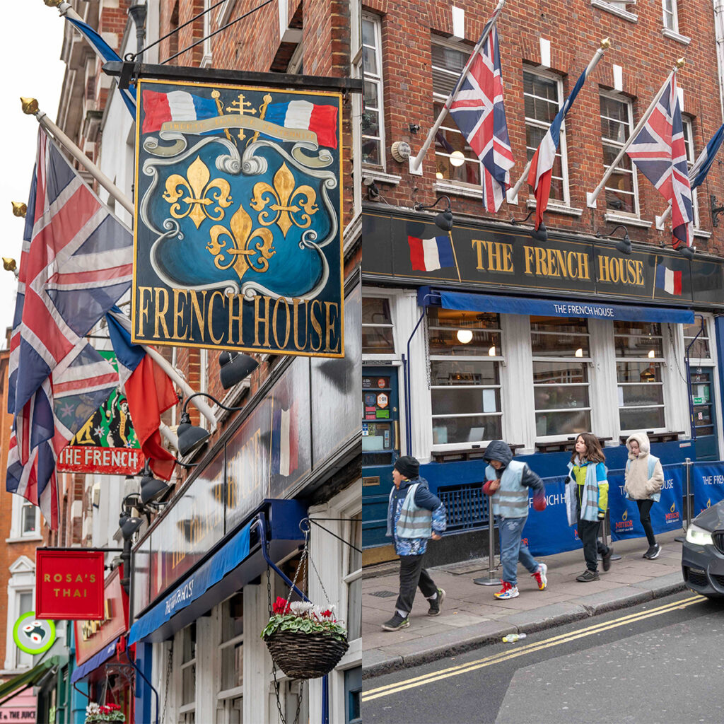 EIFA Limage montre lextérieur de The French House, un pub avec des panneaux et plusieurs drapeaux, dont des drapeaux britannique et français. Des gens marchent sur le trottoir.